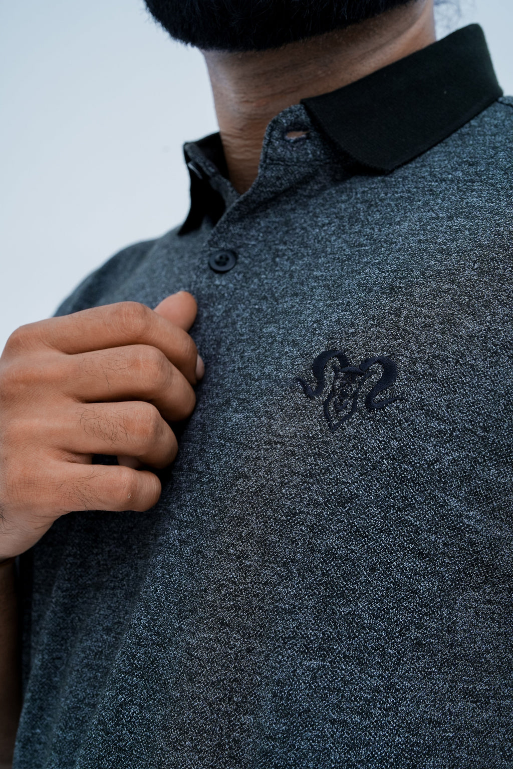 Onyx Contrast Polo - chest emblem close up